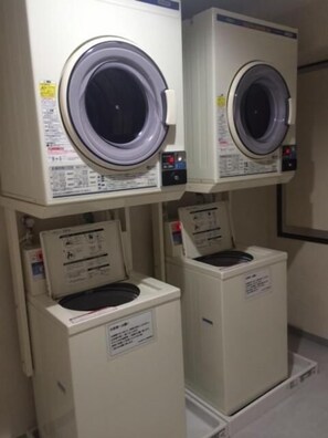 A laundry facility with multiple washing machines, each with a control panel and safety instructions. - Washington R&B Hotel Hakata Ekimae Dai 1 (Fukuoka)