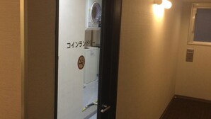 A hallway with a door labeled "Coinland Dryer" leading to a laundry area. - Washington R&B Hotel Hakata Ekimae Dai 1 (Fukuoka)