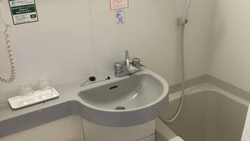 A bathroom with a sink, toilet, and bathtub.