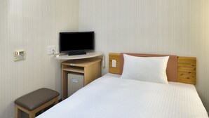A hotel room with a bed, a television on a desk, a small cabinet, and a bench. - R&B Hotel Kobe Motomachi (Kobe)