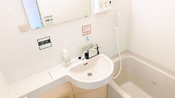 Combined shower/tub, hair dryer, slippers, bidet