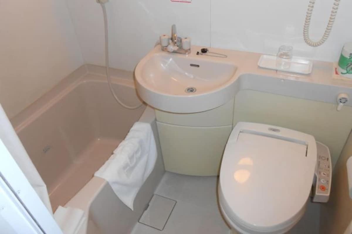 A bathroom with a bathtub, a sink, and a toilet.