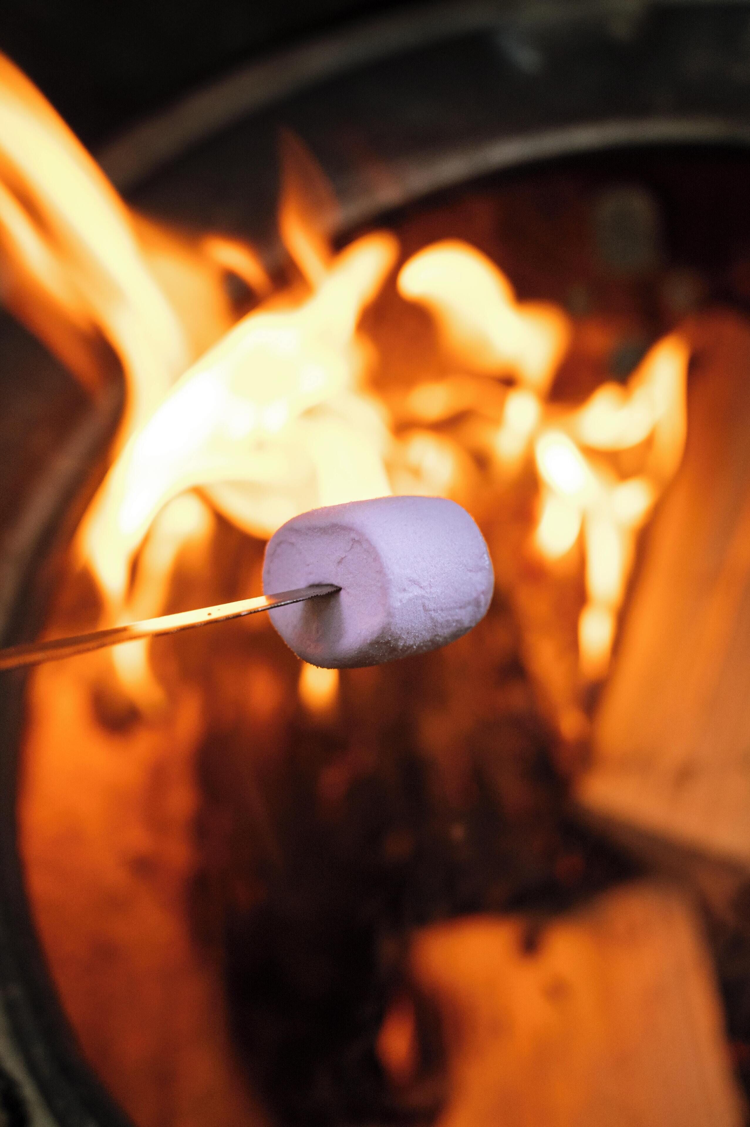 A marshmallow being roasted over a campfire.
