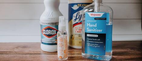 A collection of hand sanitizers on a wooden surface.