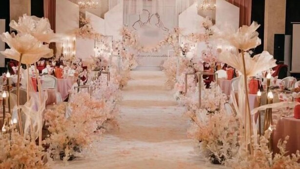 A grand staircase with floral decorations leading to a seating area, likely for a formal event. - Ganjiang Hotel (Nanchang)