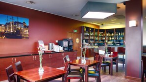A restaurant with a bar area, wooden furniture, and a cityscape painting on the wall. - Hotel Focus Gdansk (Gdansk)
