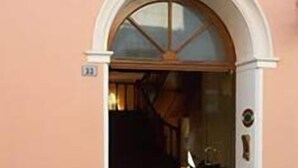 An arched entrance to a building with a door and a small window above it. - Hotel Sant'Andrea (Ravenna)