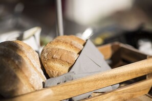 A wooden crate containing several loaves of bread.