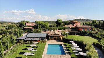 Relax by the spacious pool surrounded by lush gardens and lounge chairs.