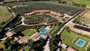 An aerial view of a large estate with multiple buildings, extensive olive groves, and two swimming pools. - Resort Locanda Rossa (Capalbio)