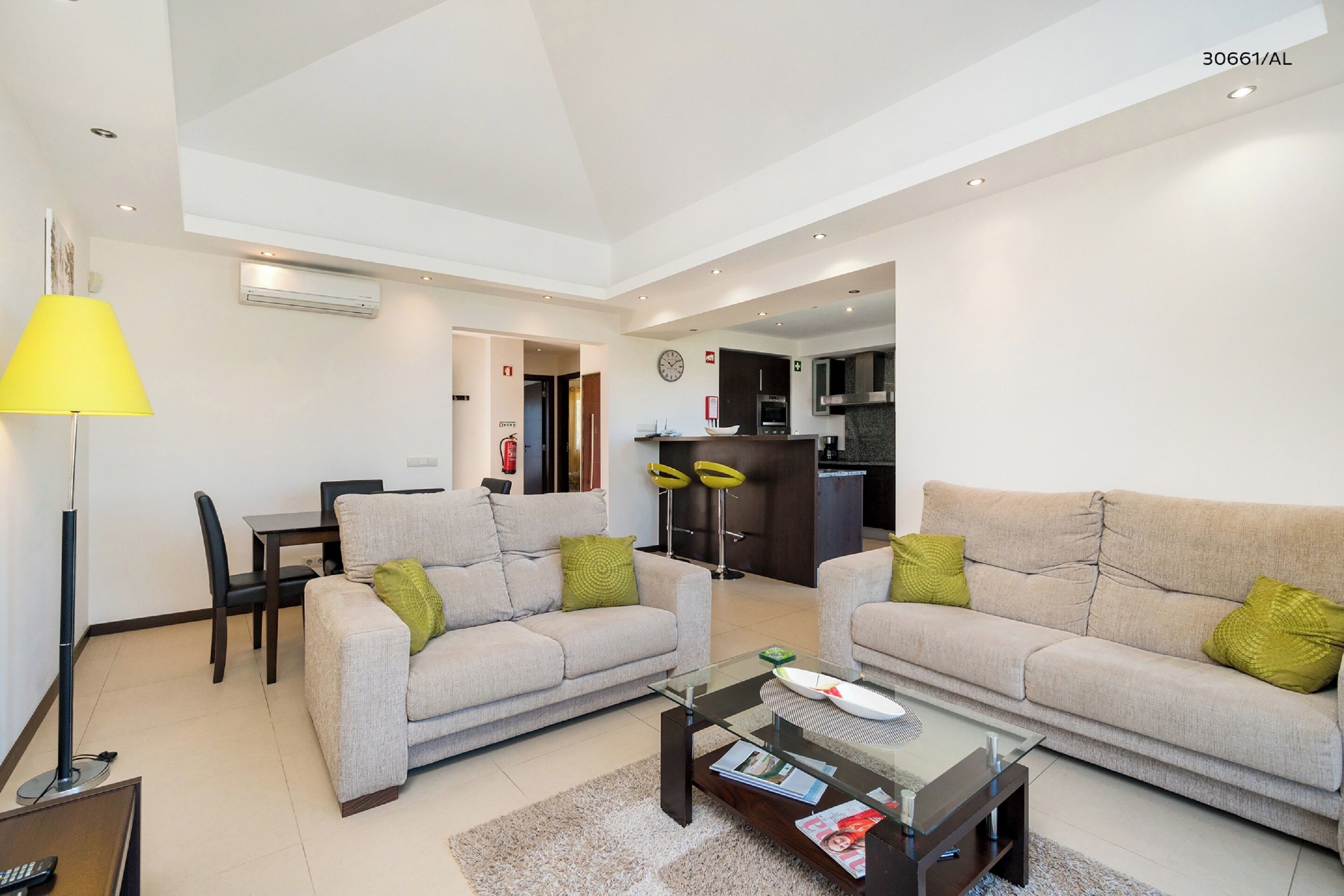 A modern living room with two sofas, a coffee table, and a dining area with a table and chairs.