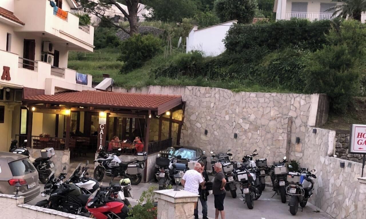 A building with a stone wall and a sign that reads 'HOTEL GALA'.