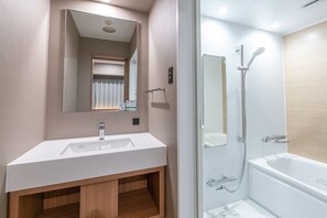 A modern bathroom with a white sink, mirror, and shower. - Washington R&B Hotel Sapporo Kita 3 Nishi 2 (Sapporo)