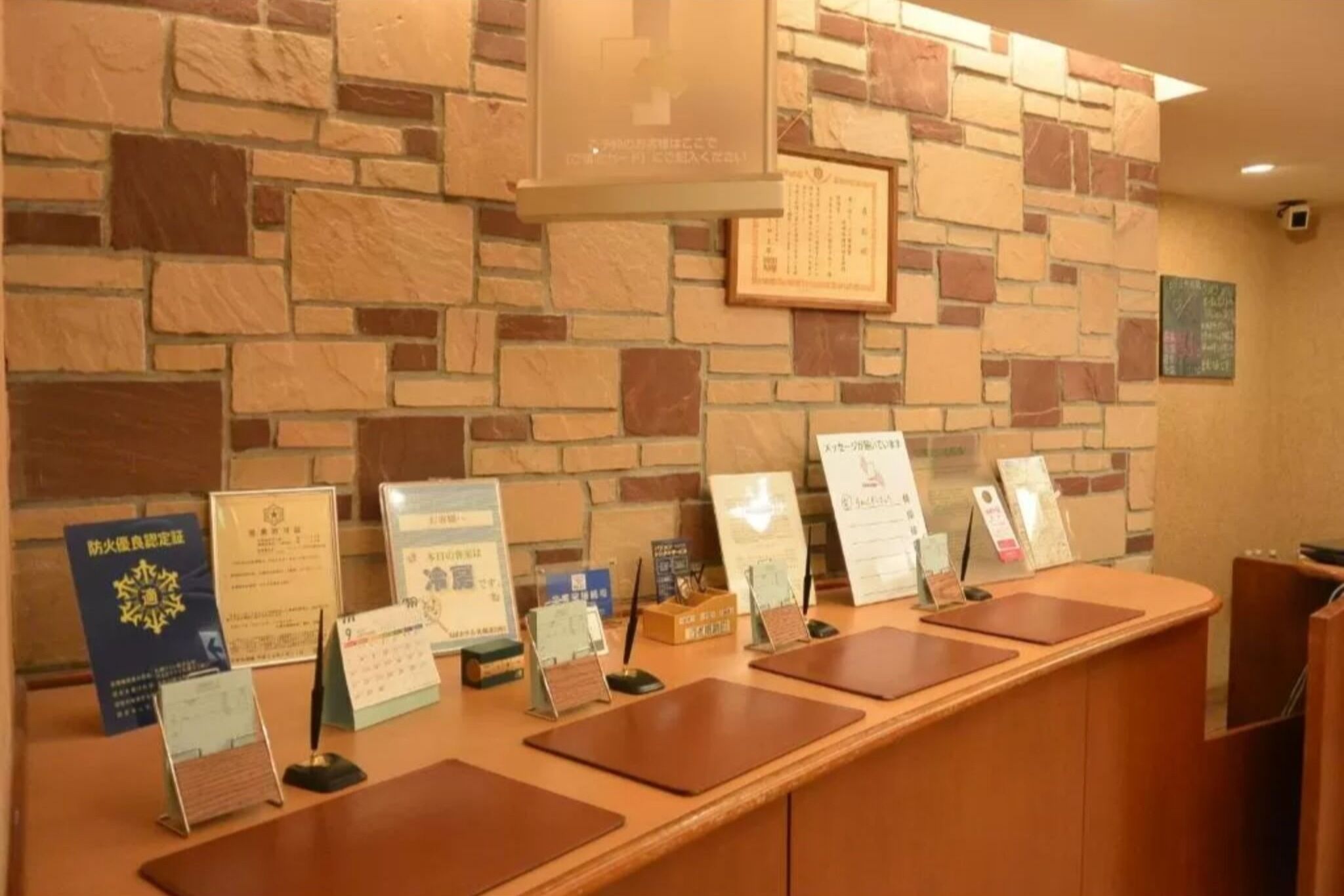 A reception desk with certificates and plaques on the wall behind it.