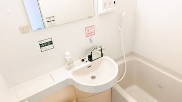 Combined shower/tub, free toiletries, hair dryer, slippers