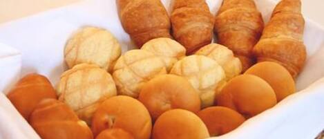 A variety of baked goods including croissants and rolls.