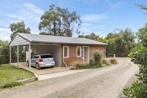 A single-story house with a covered carport and a gravel driveway. - Bruny Island Escapes and Hotel Bruny (Alonnah)