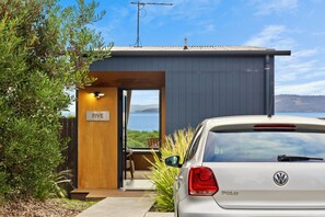 A modern building with a visible room number 'FIVE' and a parked white car. - Bruny Island Escapes and Hotel Bruny (Alonnah)