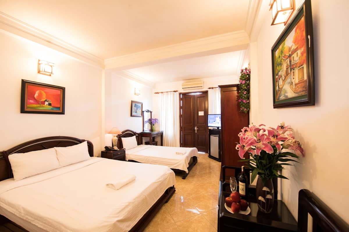 Family Triple Room | Minibar, in-room safe, desk, blackout drapes