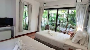 A hotel room with two beds, a TV, and large windows with curtains. - Samui Honey Cottages Beach Resort (Koh Samui)
