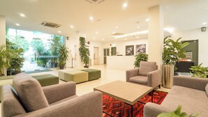 A modern lobby with sofas, a coffee table, and potted plants. - Tune Hotel KLIA Aeropolis (Sepang)