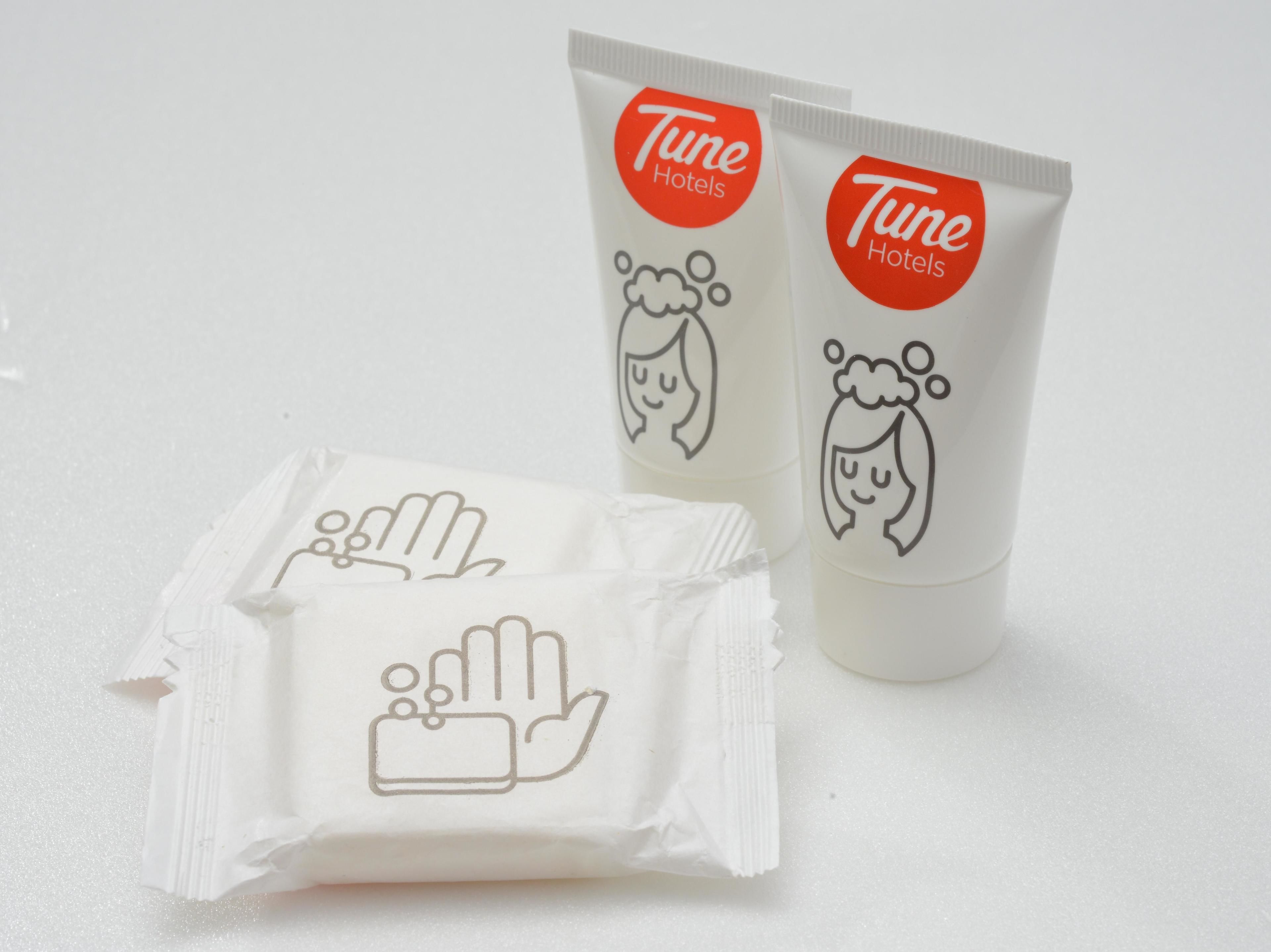 Two tubes of Tune Hotels hand sanitizer and a packet of hand wipes.