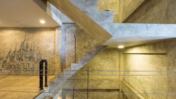 A modern interior with a large staircase, a mural of a castle, and a minimalist design. - Buddy Boutique Inn (Bangkok)