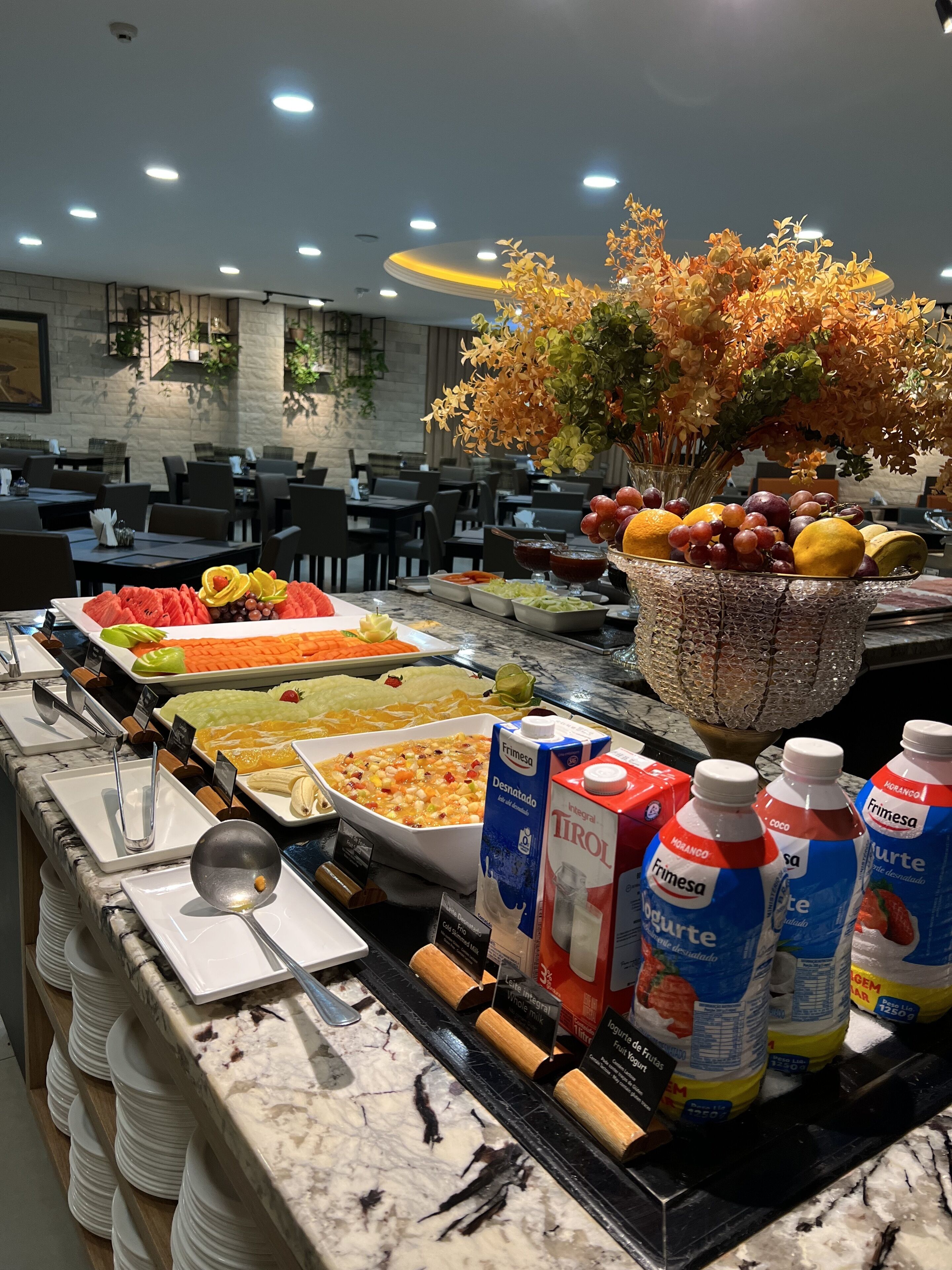 A buffet with various food items, including fruits, vegetables, and dairy products.