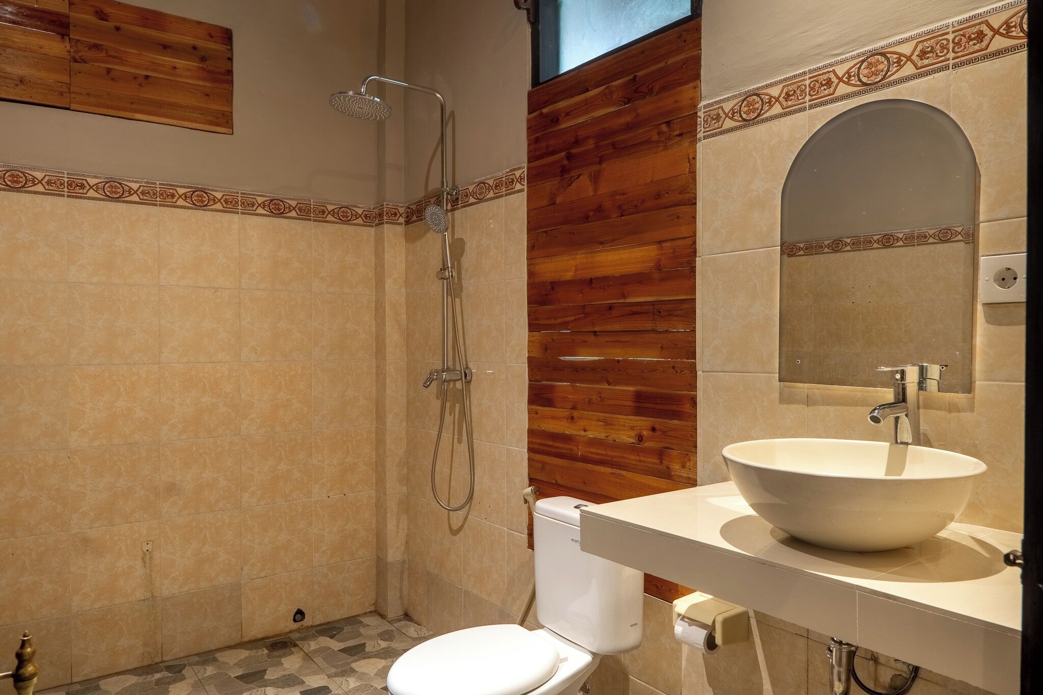 A bathroom with a shower, toilet, and sink.