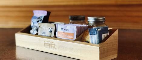 A wooden box containing various items, including a box labeled "Porters Premium Classic Blend" and other small containers.