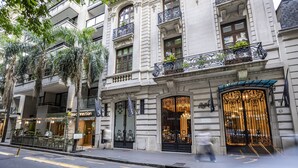 A historic building with ornate iron balconies, large windows, and a prominent entrance. - Algodon Mansion (Buenos Aires)
