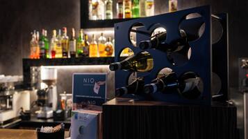A bar area with a wine display and a NIO sign.
