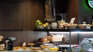 A buffet with various food items and a coffee machine. -  Divina Luxury Hotel (Rome)