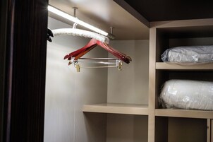 A closet with shelves and a hanging rod.