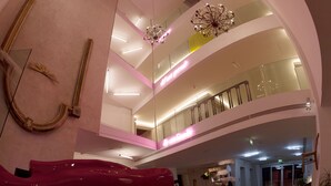 A multi-level atrium with modern architecture, including a curved ceiling and glass railings. - Aiden by Best Western JHD Dunant Hotel (Castiglione delle Stiviere)