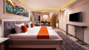 A modern hotel room with a large bed, a flat-screen TV, and a painting on the wall. - Harbiye Residence (Istanbul)
