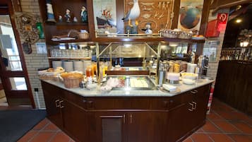 Enjoy a sumptuous spread at our buffet, featuring a variety of dishes and fresh bread.