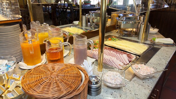 A buffet with various food items and beverages.