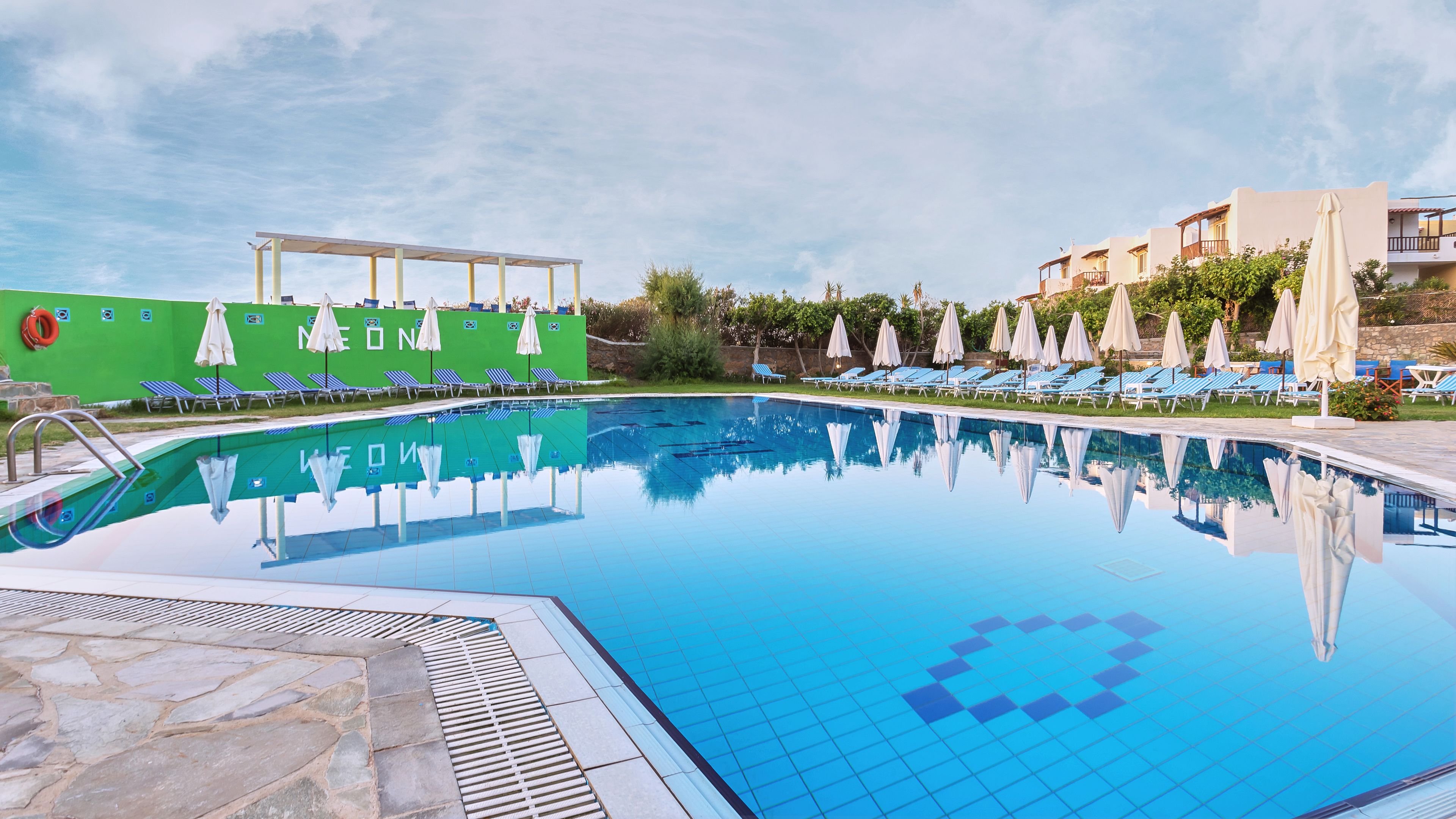 Een seizoensgebonden buitenzwembad en parasols bij het zwembad