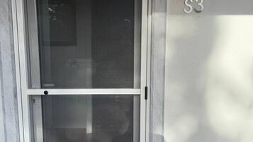 A door with a metal number plate reading "S3" on the wall beside it.