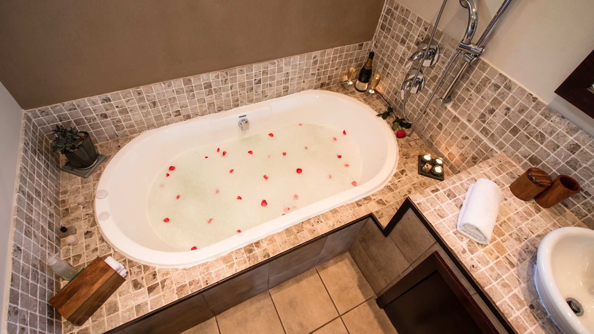 A bathroom with a freestanding bathtub, a sink, and a shower area.