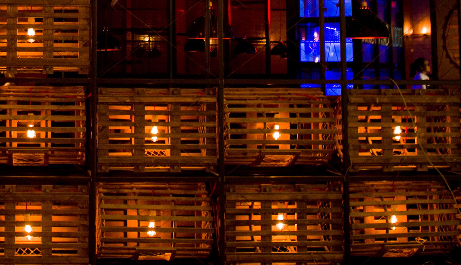 Stacked wooden crates with visible light fixtures inside.