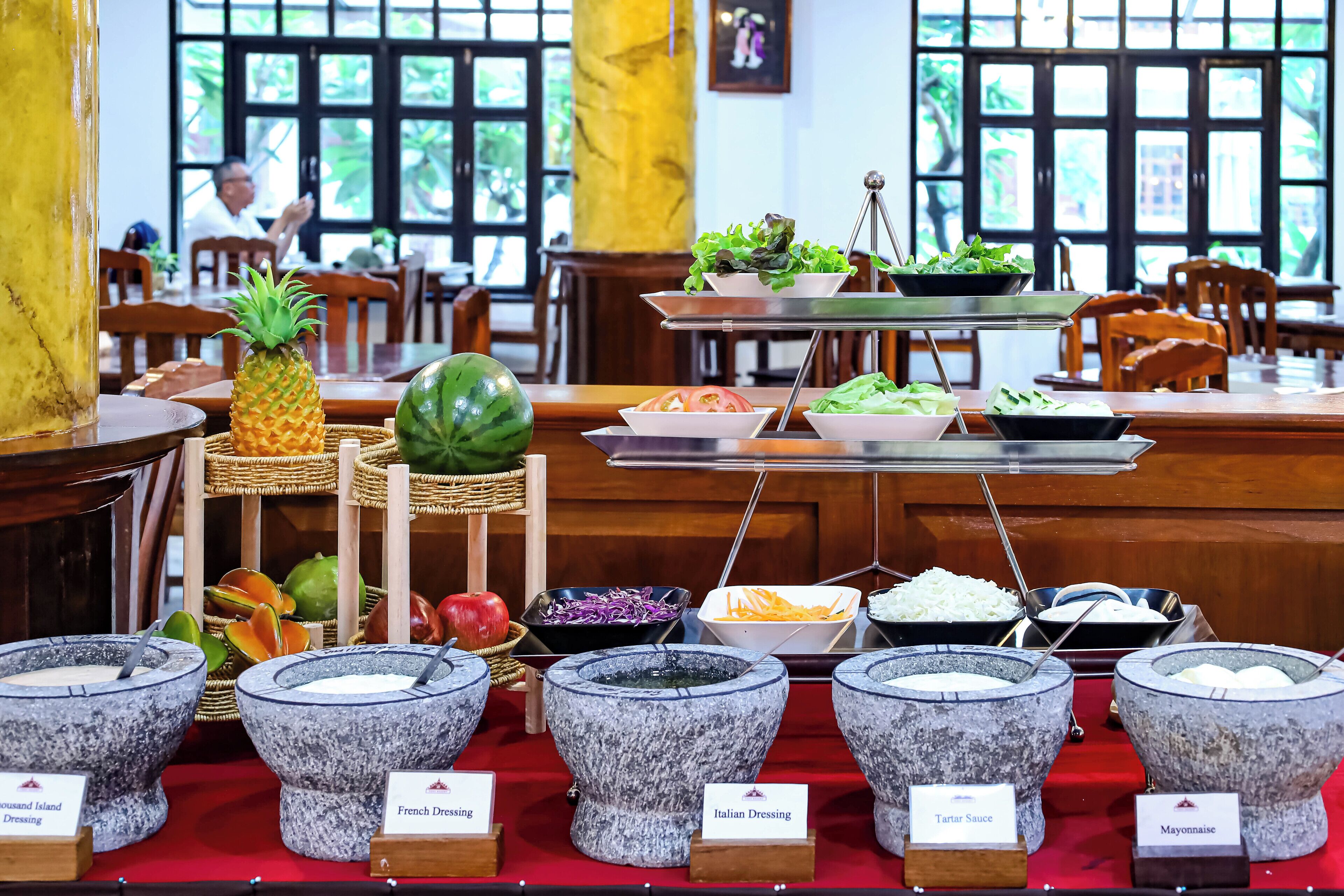 A buffet with various food options and dressings.