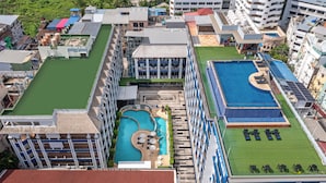 A resort with multiple swimming pools, a tennis court, and a variety of building structures. - Amata Patong (Patong)