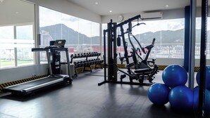 A gym with a treadmill, weight machines, and exercise balls. - Amata Patong (Patong)