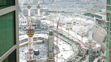 A view of a large mosque with multiple minarets and a central courtyard.