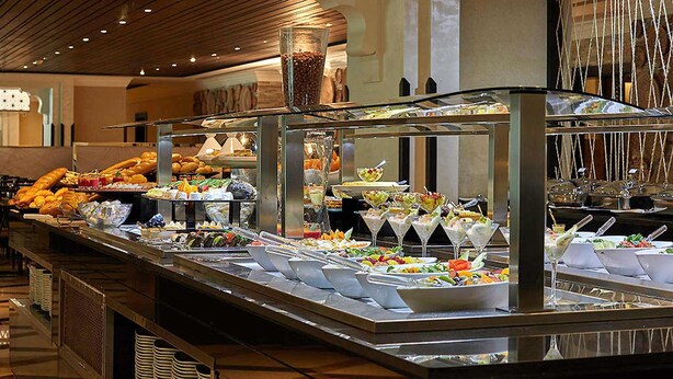 A buffet with various food items and drinks, including fruits, salads, and beverages. - Zamzam Pullman Makkah (Makkah)