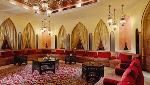 A luxurious lounge with ornate chandeliers, red sofas, and intricate wall designs. - Zamzam Pullman Makkah (Makkah)