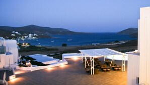 A rooftop terrace with seating and a view of the sea. - Castellano Village (Astypalaia)