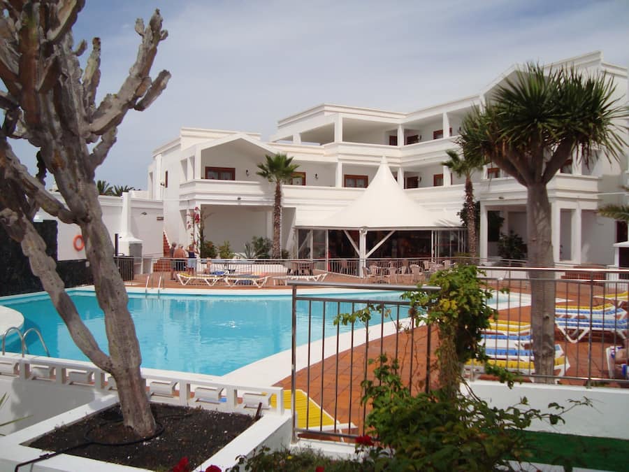 Una piscina al aire libre, sombrillas, tumbonas